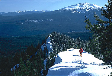 Diamond Peak is seen here from Mt. Fuji near Waldo Lake, with Eugene writer Doug Newman in the foreground,
Diamond is one of the many high peaks of the Southern Oregon Cascades and even has a residual glacier